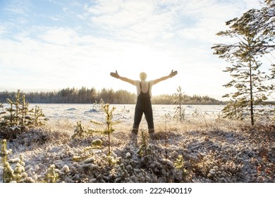 An athletic man wipes his face with clean snow in the woods. Brutal man hardens to increase immunity. Nature power antistress winter concept. - Shutterstock ID 2229400119