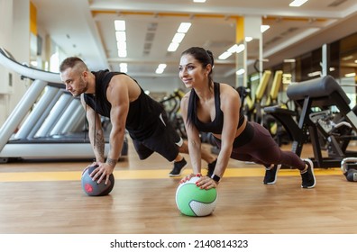 Athletic man and woman are training together with medicine ball in modern gym. Healthy lifestyle - Powered by Shutterstock