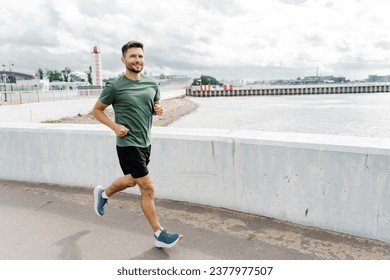 Athletic man young running training outdoors.  Exercises in sportswear and running shoes.