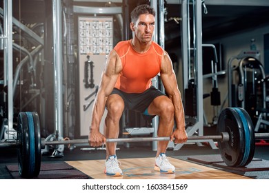 Athletic Men Preparing To Do Barbell Dead Lift In The Gym