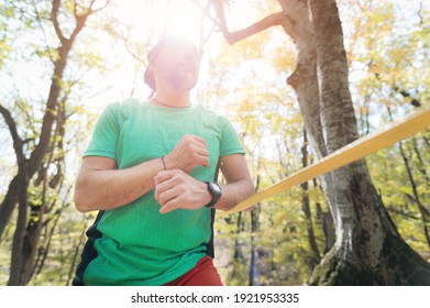 Athletic Middle Aged Man Highliner Stands In Front Of A Tight Rope Before Free Mountain Climbing In The Forest In Autumn