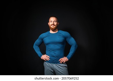 Athletic muscular smiling man posing on a black background. Copy space. Sports advertising concept. - Powered by Shutterstock