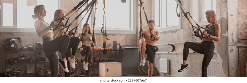 Athletic people doing crossfit training in gym - Powered by Shutterstock