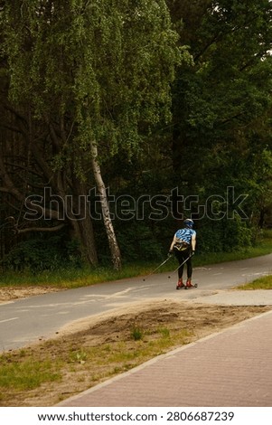 Athletic person training on roller skis along a forest trail in summerб сross country ski dryland training, roller skiing endurance workout, outdoor summer fitness, Nordic sport conditioning