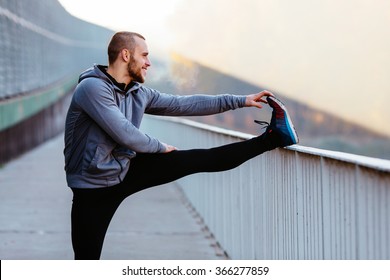 Athletic Runner Doing Stretching Exercise, Preparing For Morning Workout In The Park