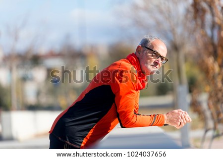 Similar – Senior runner man sitting after jogging in a park