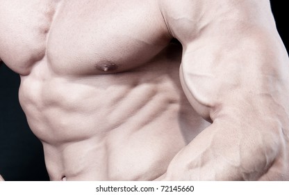 Athletic Sexy Attractive Male Body Builder, Demonstrating Contest Pose. Studio Shot