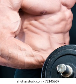 Athletic Sexy Attractive Male Body Builder, Demonstrating Contest Pose. Studio Shot