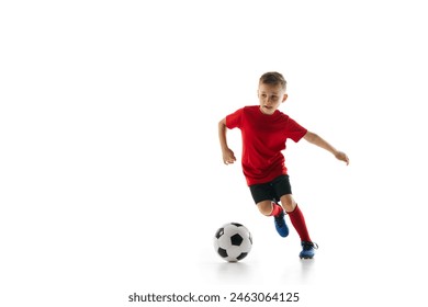 Athletic, sportive boy in uniform training dribbling technique in motion against white studio background. Dynamic shot. Concept of professional sport, championship, youth league, hobby. Ad - Powered by Shutterstock