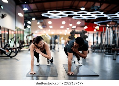 Athletic Sportsman and Sportswoman Doing Push Ups Together at Fitness Gym: Strength, Unity, and Motivation - Powered by Shutterstock