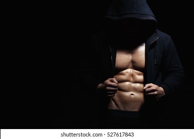 Athletic Strong Sexual Man Abs Six Pack Muscles Bodybuiding And Fitness Concept. Studio Shot, Low Key, Copy Space On Black Background