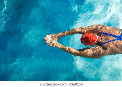 Athletic swimmer is diving in a swimming pool - Powered by Shutterstock