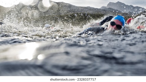 Athletic swimmers splashing in water