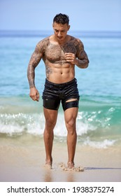 Athletic Tattooed Guy Walking At The Tropical Beach