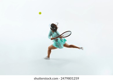 Athletic tennis player in turquoise attire executes forehand swing, her intense focus and dynamic movement highlighted. Concept of professional sport, championship, active lifestyle, tournament. Ad - Powered by Shutterstock