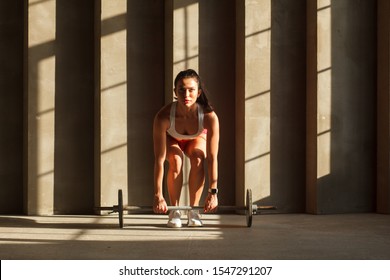Athletic Woman Doing Dead Lift Exercise With Barbell In Gym