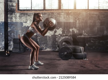 Athletic Woman Doing Fitness Training Holding A Medicine Ball.