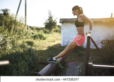 athletic woman doing push-ups on the nature.
