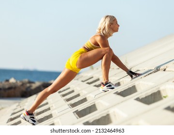 Athletic Woman Exercising From A Concrete Surface On The Beach. Fitness, Outdoor Aerobics Concept