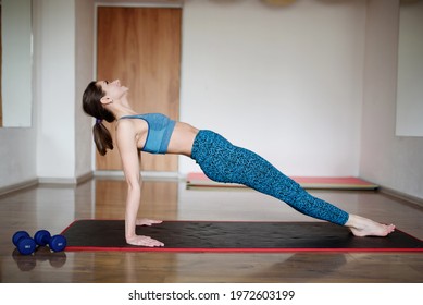 Athletic woman performs reverse plank exercise in gym - Powered by Shutterstock