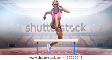 Athletic woman practicing show jumping against view of a stadium