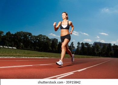 Athletic Woman Running On Track