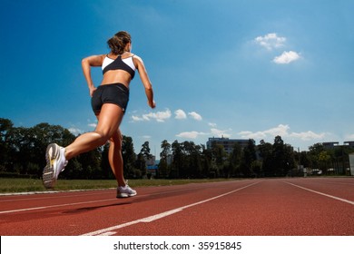 Athletic Woman Running On Track