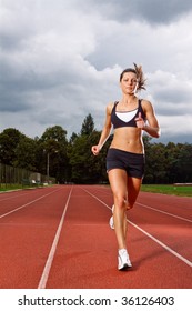 Athletic Woman Running On Track