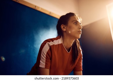 Athletic woman thinking of something before soccer match in dressing room. - Powered by Shutterstock