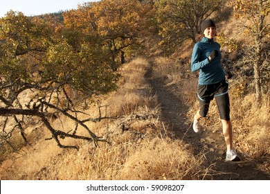 An Athletic Woman Trail Running In Oregon.