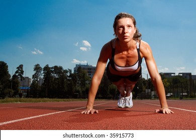 Athletic woman working out on track