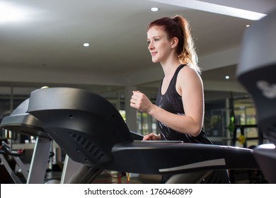 Athletic Woman Workout In The Gym Have A Partition For Treadmill, Concept Lifestyle  Social Distance