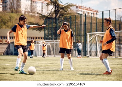 Athletic women practicing with ball during soccer training at the stadium. - Powered by Shutterstock