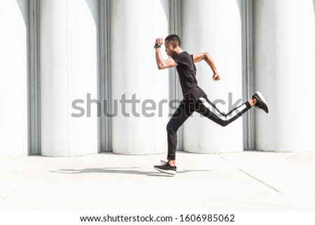 Similar – Happy man and jumping outdoors, warmup before jogging