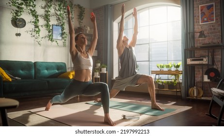 Athletic Young Couple Exercising Together, Stretching and Doing Yoga in the Morning in Bright Sunny Room at Home. Beautiful Man and Woman in Sports Clothes Practising Different Asana Poses on the Mat. - Powered by Shutterstock