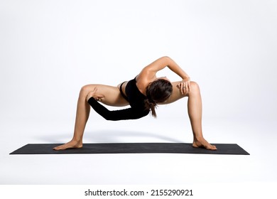 Athletic Young Girl Exercising, Yoga, Pilates, Fitness Training, Sumo Squat Exercises, Rotating Temple, Goddess, Sumo Wrestler Pose. White Background Studio