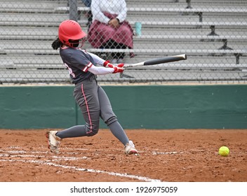 Athletic young girl playing in a fastpitch softball game - Powered by Shutterstock