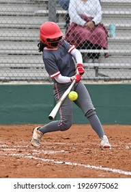 Athletic Young Girl Playing In A Fastpitch Softball Game