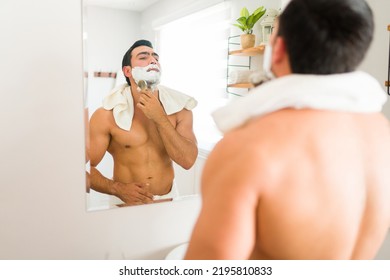 Athletic Young Latin Man Using Shaving Cream In His Beard With A Brush Before Shaving And Grooming