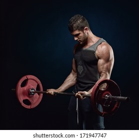 Athletic Young Man Lifting Weights