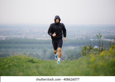 Athletic Young Man Running During Autumn, Winter Morning. Healthy Lifestyle