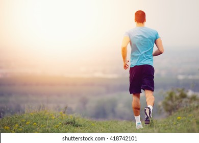 Athletic Young Man Running In The Nature. Healthy Lifestyle