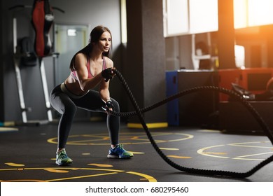 Athletic Young Woman Doing Crossfit Exercises With A Rope 