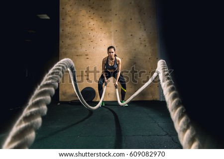 Similar – Image, Stock Photo Female athlete training in a gym using sport equipment