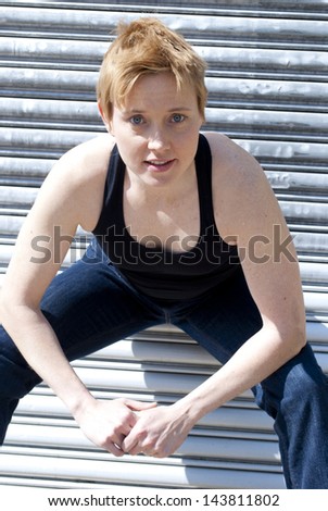 Similar – Close up front upper body portrait of one young athletic woman in sportswear in gym over dark background, looking at camera