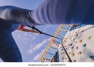 Athletic young woman working out and climbing at the artificial rock in training camp. - Powered by Shutterstock