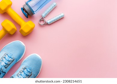 Athletics set with sneakers and dumbbells, top view. - Powered by Shutterstock