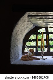 Atla / Estonia - July 21 2018: Interior Of The Stone Manor House, Built In The Second Half Of The 18th Century. Window Of The Dormer, Dog Figure And Tall Candles On Window Sill. European Union.