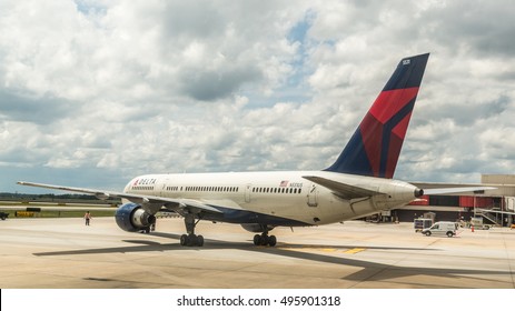 Atlanta - Aug 30: A Ground Technician At Atlanta International Airport Directs A Delta Air Plane Out Of Its Departure Gate For Takeoff On Aug 30, 2014 In Atlanta, Georgia.