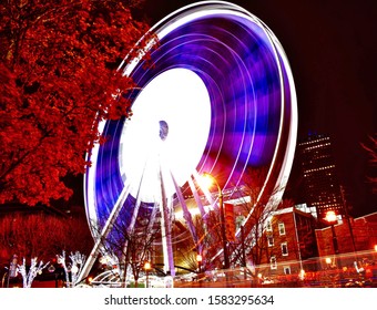 Atlanta Ferris Wheel Illuminated At Night With Light Trails And Foliage